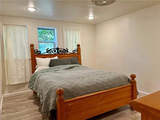 a bed sitting in a bedroom next to a window