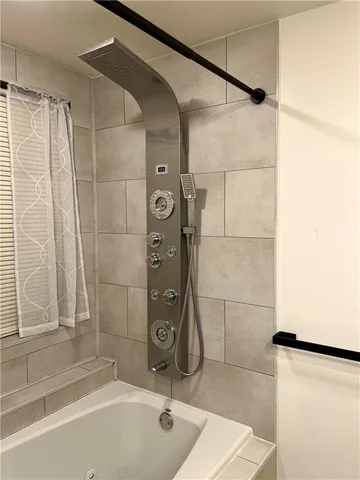 a bathroom with a shower and a tub