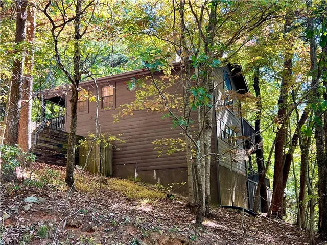a backyard of a house with lots of trees