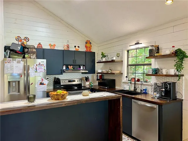a kitchen with a sink appliances and cabinets