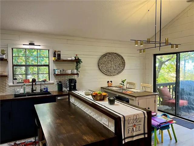 a kitchen with a stove a table and chairs