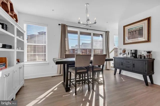 a spacious bedroom with a bed and dresser