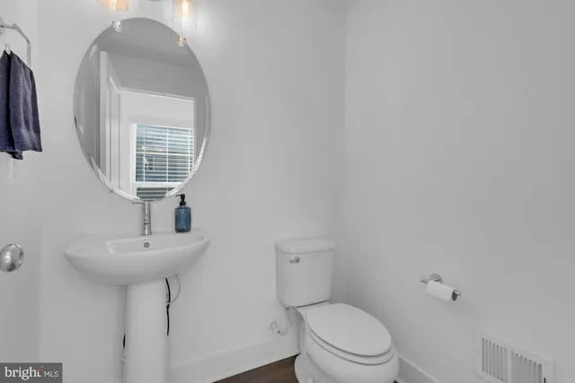 a view of a closet area with hardwood