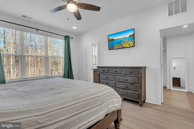 a spacious bathroom with a double vanity sink a mirror and a shower