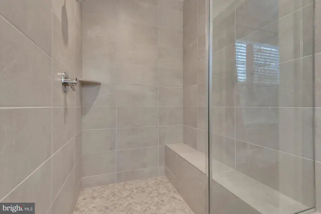 a living room with furniture and a baby crib