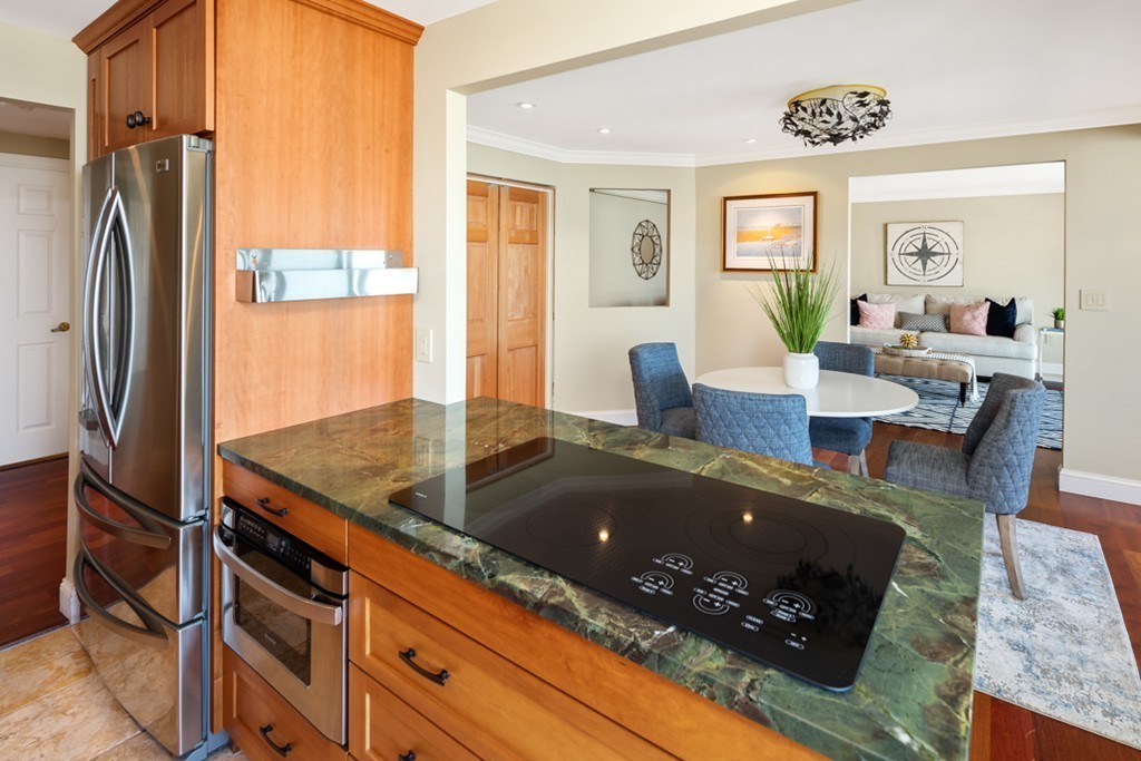 1 Commodore Court, Unit 405 Hull, MA 02045 - Photo 12 of 26 a living room with granite countertop furniture and a fireplace