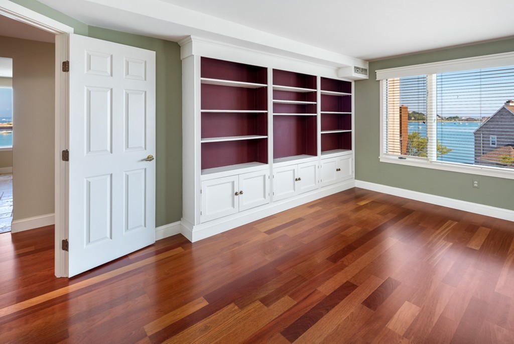 1 Commodore Court, Unit 405 Hull, MA 02045 - Photo 17 of 26 wooden floor in an empty room with a window