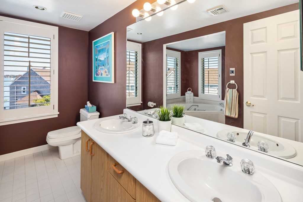 1 Commodore Court, Unit 405 Hull, MA 02045 - Photo 20 of 26 a bathroom with a sink and a mirror