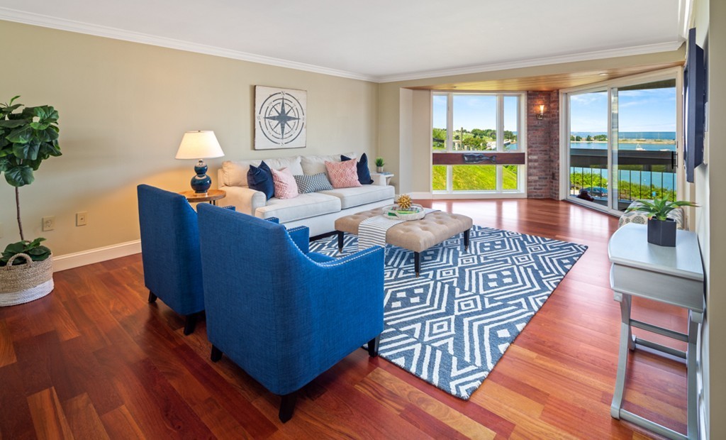 1 Commodore Court, Unit 405 Hull, MA 02045 - Photo 2 of 26 a living room with furniture and a large window