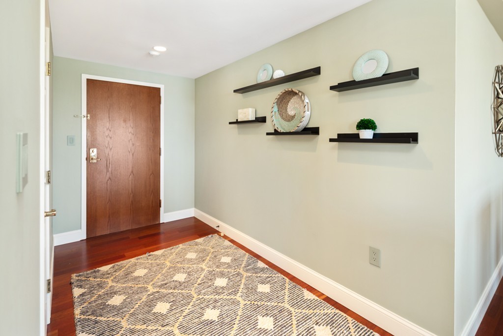1 Commodore Court, Unit 405 Hull, MA 02045 - Photo 22 of 26 a view of a hallway with wooden floor