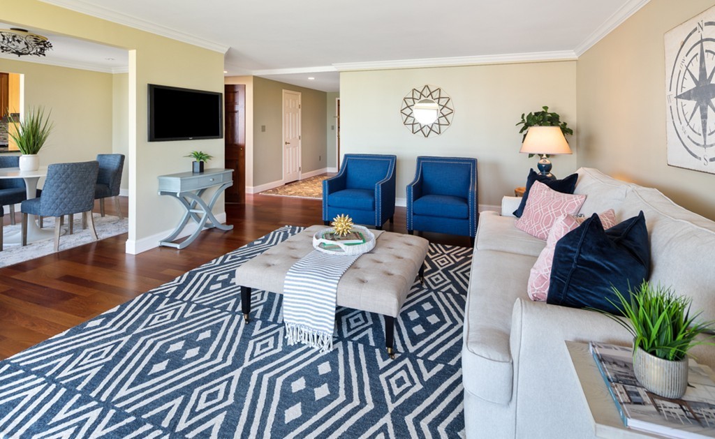 1 Commodore Court, Unit 405 Hull, MA 02045 - Photo 3 of 26 a living room with furniture a flat screen tv and a potted plant