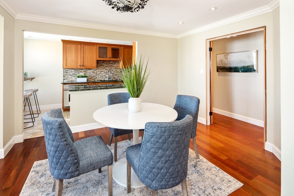1 Commodore Court, Unit 405 Hull, MA 02045 - Photo 5 of 26 a dining room with furniture and wooden floor