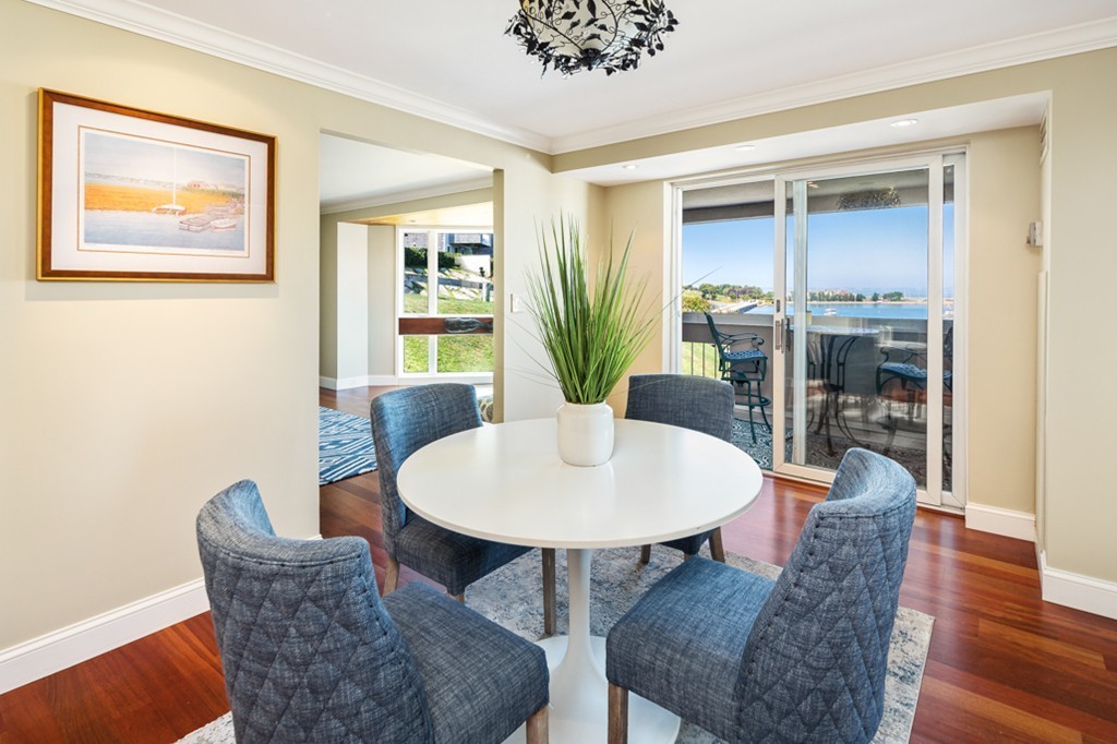 1 Commodore Court, Unit 405 Hull, MA 02045 - Photo 6 of 26 a dining room with furniture and wooden floor