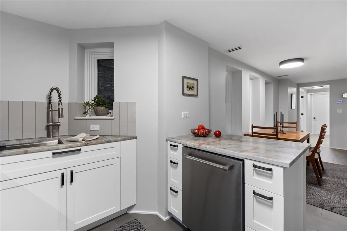 159 West Burton Place, Unit G Chicago, IL 60610 - Photo 17 of 37 a kitchen with a sink cabinets and wooden floor