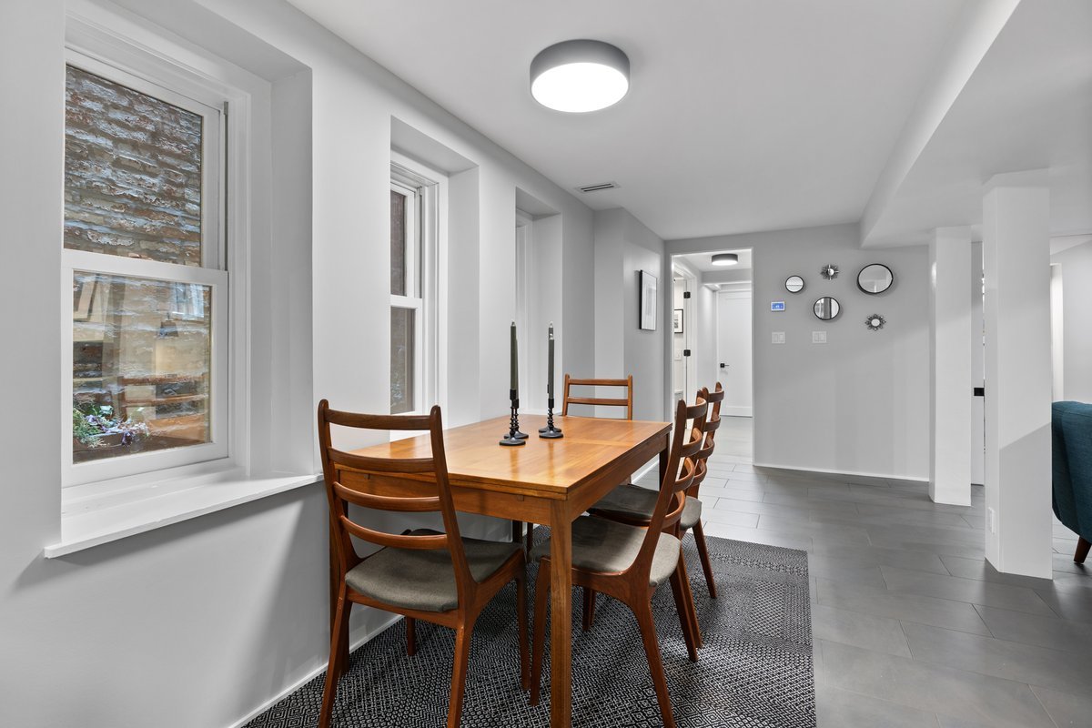 159 West Burton Place, Unit G Chicago, IL 60610 - Photo 21 of 37 a dining room with furniture and wooden floor