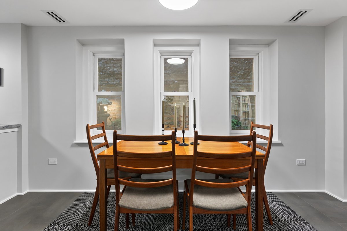 159 West Burton Place, Unit G Chicago, IL 60610 - Photo 24 of 37 a dining room with furniture and window