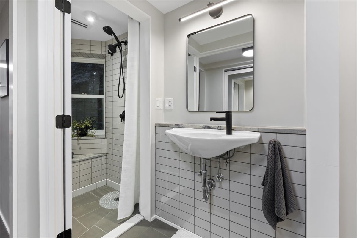 159 West Burton Place, Unit G Chicago, IL 60610 - Photo 27 of 37 a bathroom with a sink a mirror and shower