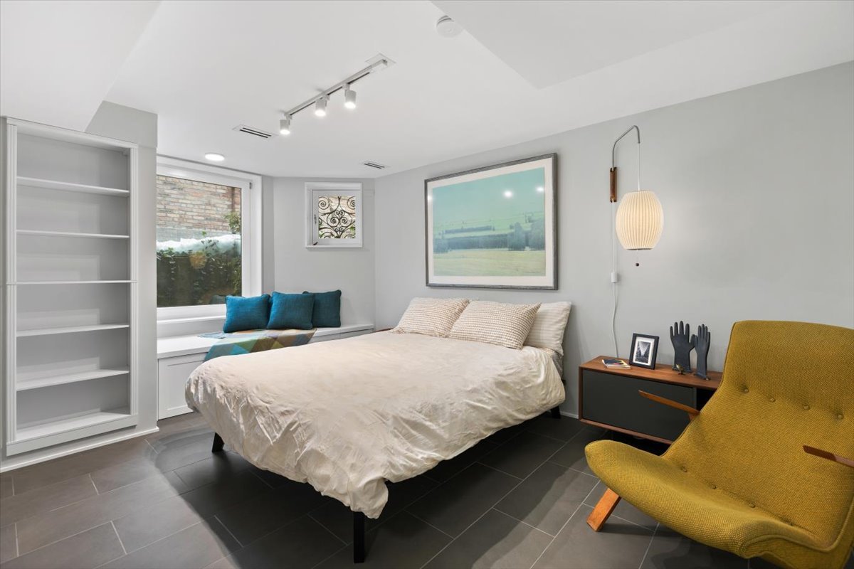 159 West Burton Place, Unit G Chicago, IL 60610 - Photo 29 of 37 a bedroom with a bed and window