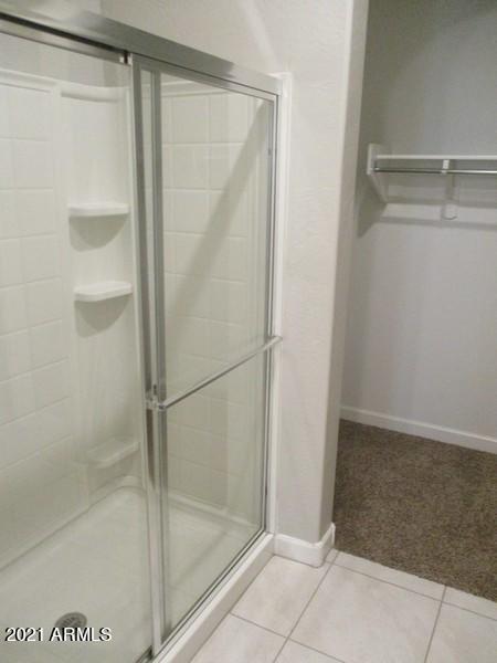 1367 South Country Club Drive, Unit 1153 Mesa, AZ 85210 - Photo 11 of 48 a bathroom with a glass shower door
