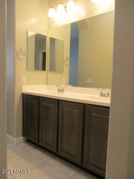 1367 South Country Club Drive, Unit 1153 Mesa, AZ 85210 - Photo 12 of 48 a bathroom with a double vanity sink and a mirror