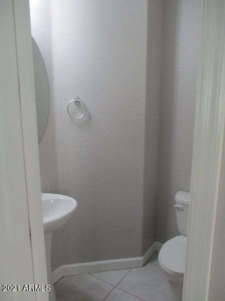 1367 South Country Club Drive, Unit 1153 Mesa, AZ 85210 - Photo 13 of 48 a bathroom with a granite countertop toilet and a sink