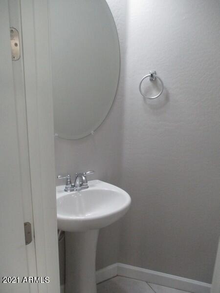 1367 South Country Club Drive, Unit 1153 Mesa, AZ 85210 - Photo 14 of 48 a bathroom with a sink a toilet and mirror