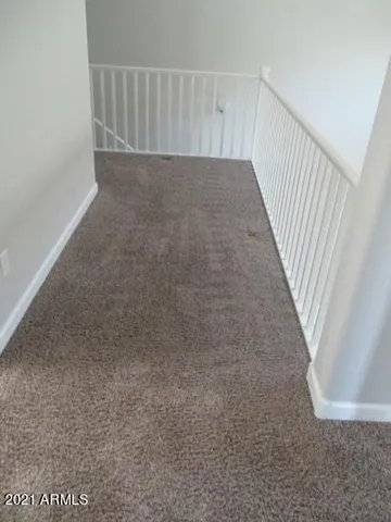 a view of a fountain in front of a house with a big yard