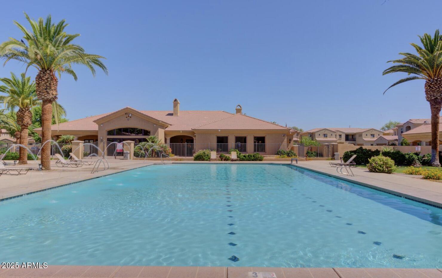 1367 South Country Club Drive, Unit 1153 Mesa, AZ 85210 - Photo 31 of 48 a front view of a house with a yard and garage