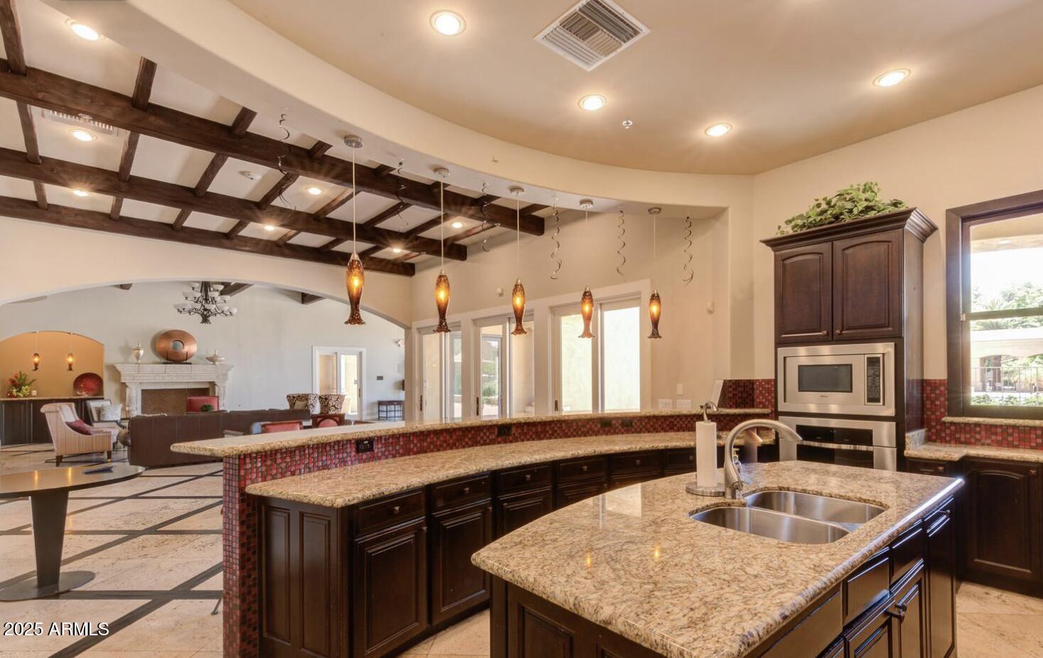 1367 South Country Club Drive, Unit 1153 Mesa, AZ 85210 - Photo 32 of 48 a kitchen with granite countertop a sink a counter and chairs