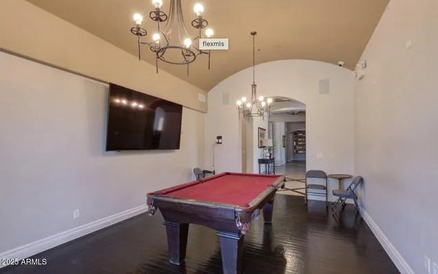 a living room with fireplace furniture and a chandelier