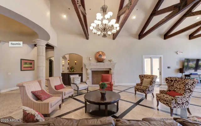 a view of a livingroom with furniture wooden floor and a chandelier