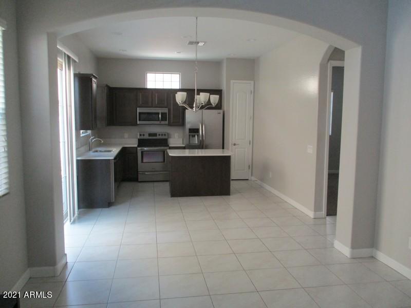 1367 South Country Club Drive, Unit 1153 Mesa, AZ 85210 - Photo 4 of 48 a kitchen with cabinets and stainless steel appliances
