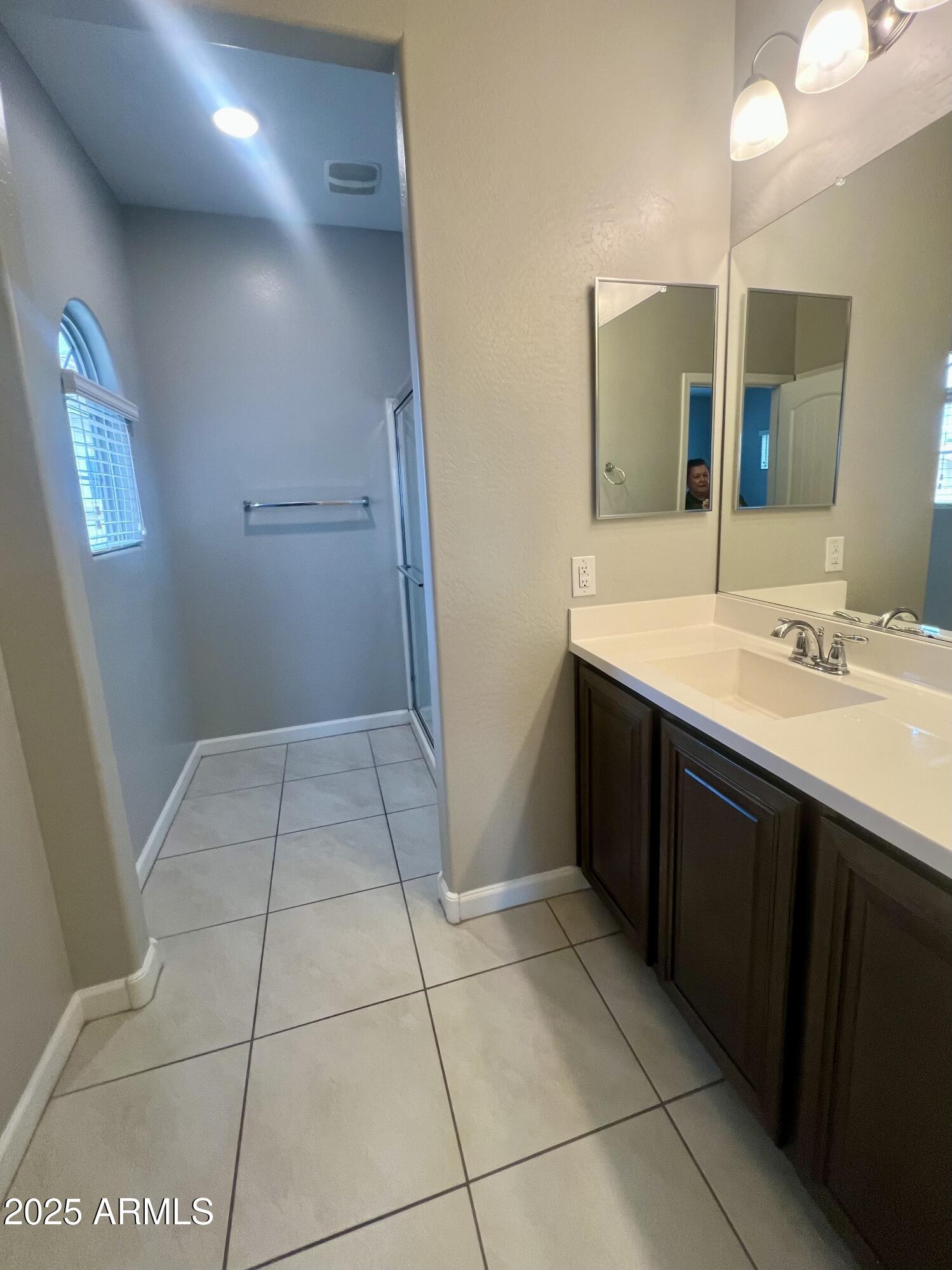 1367 South Country Club Drive, Unit 1153 Mesa, AZ 85210 - Photo 41 of 48 a bathroom with a sink a toilet and mirror