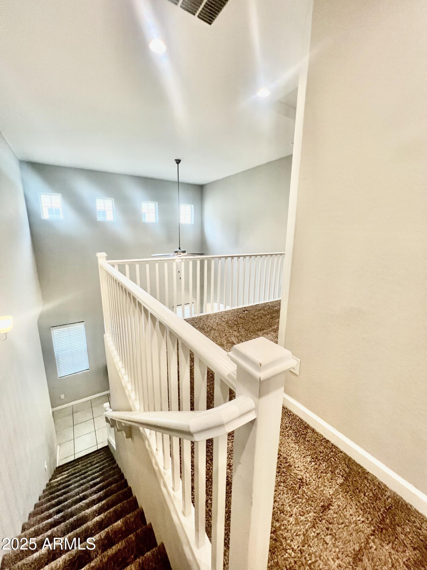 1367 South Country Club Drive, Unit 1153 Mesa, AZ 85210 - Photo 43 of 48 a view of staircase with white walls and a window