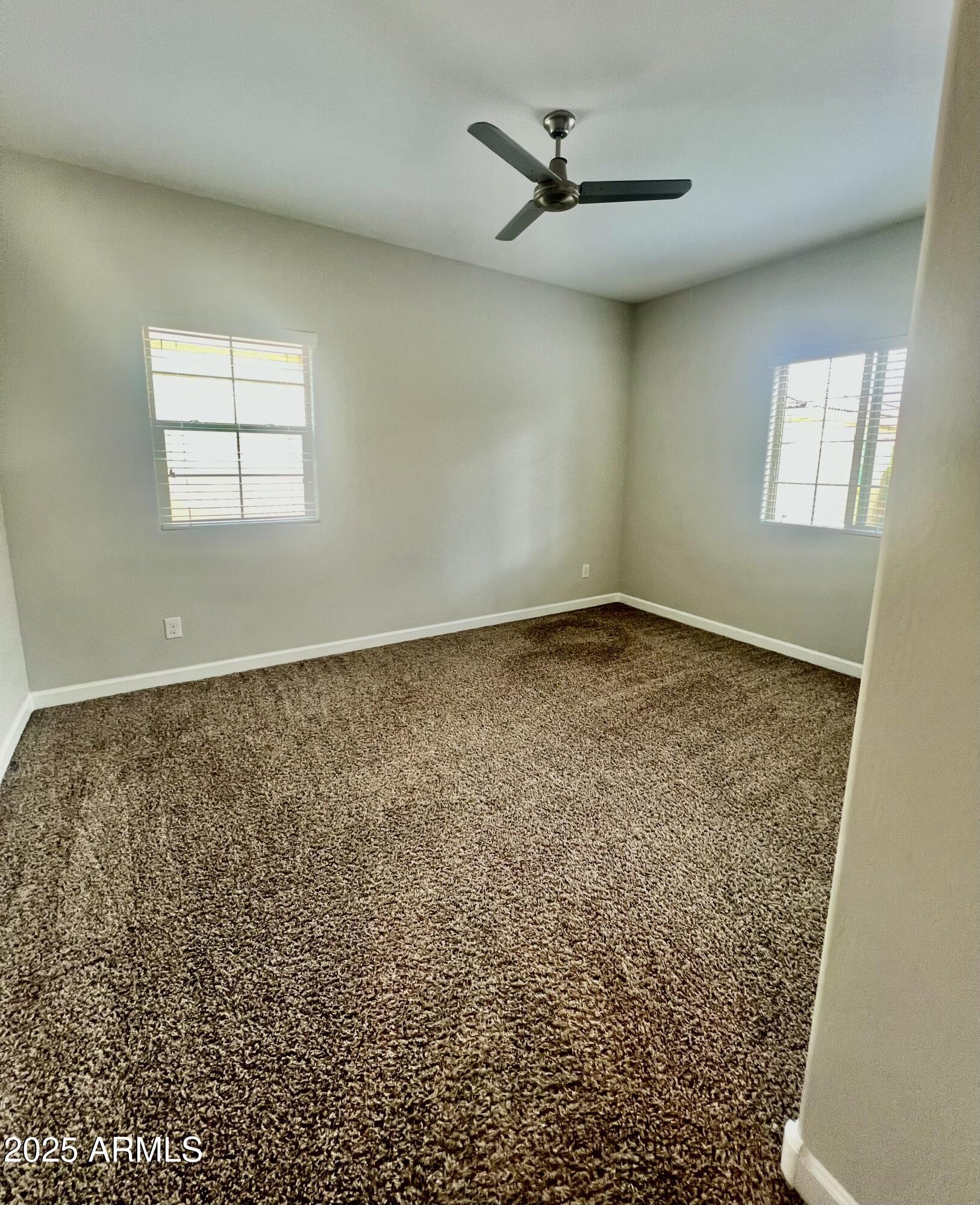 1367 South Country Club Drive, Unit 1153 Mesa, AZ 85210 - Photo 45 of 48 an empty room with a empty space and windows