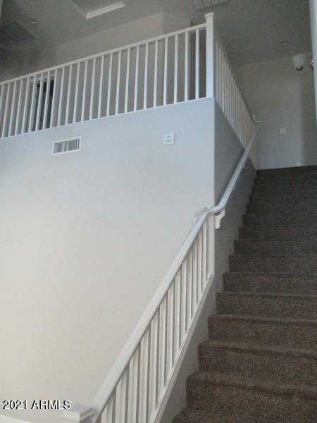 1367 South Country Club Drive, Unit 1153 Mesa, AZ 85210 - Photo 6 of 48 a view of staircase with railing and a window