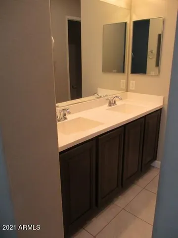 a bathroom with a granite countertop sink and mirror