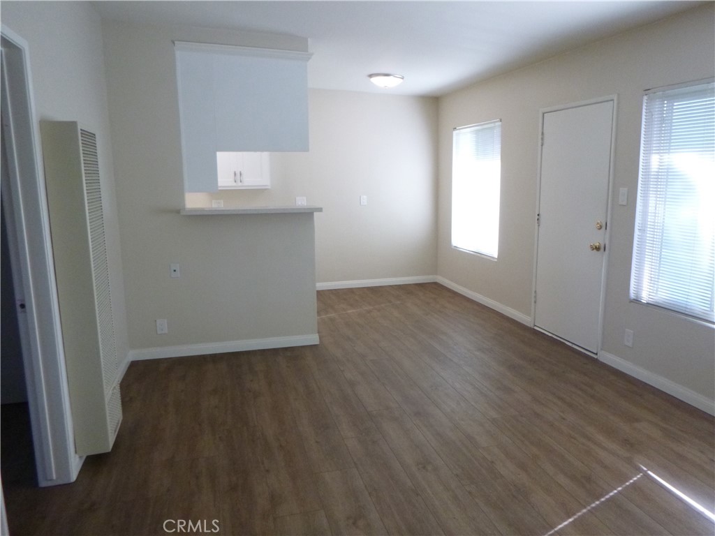 620 Prospect Avenue Long Beach, CA 90814 - Photo 5 of 11 an empty room with wooden floor and windows