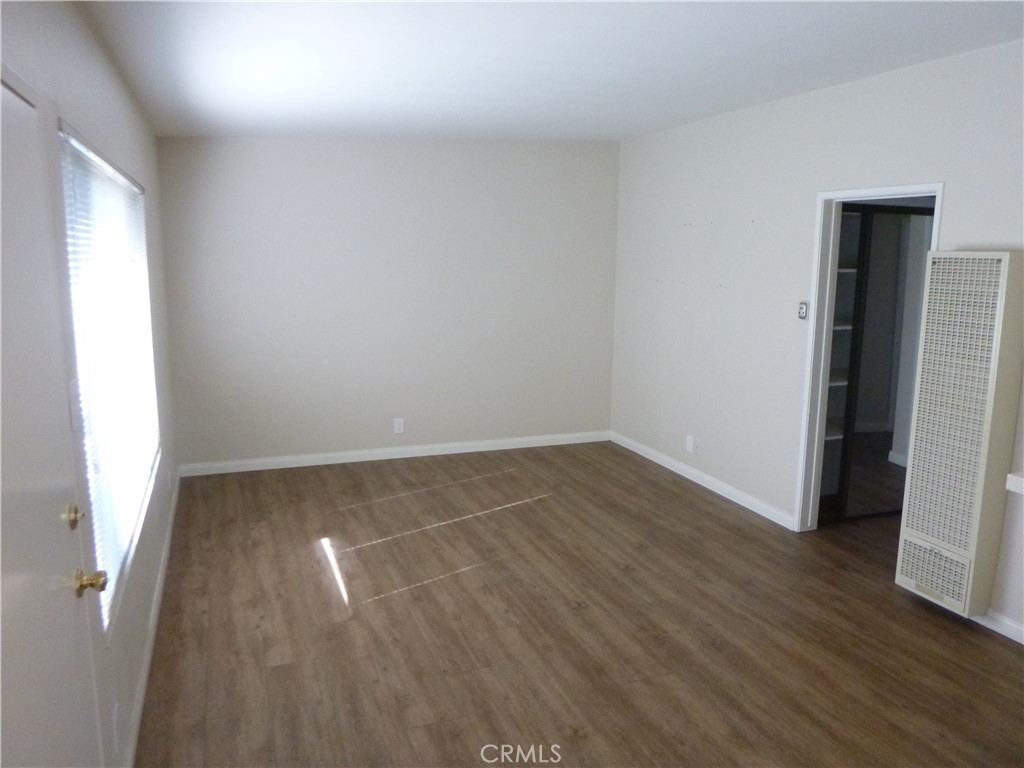 620 Prospect Avenue Long Beach, CA 90814 - Photo 7 of 11 a view of an empty room with wooden floor and a window