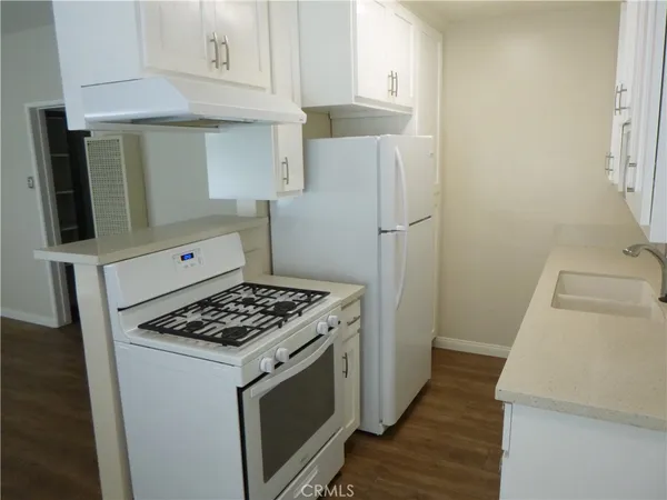 a kitchen with a stove and a refrigerator