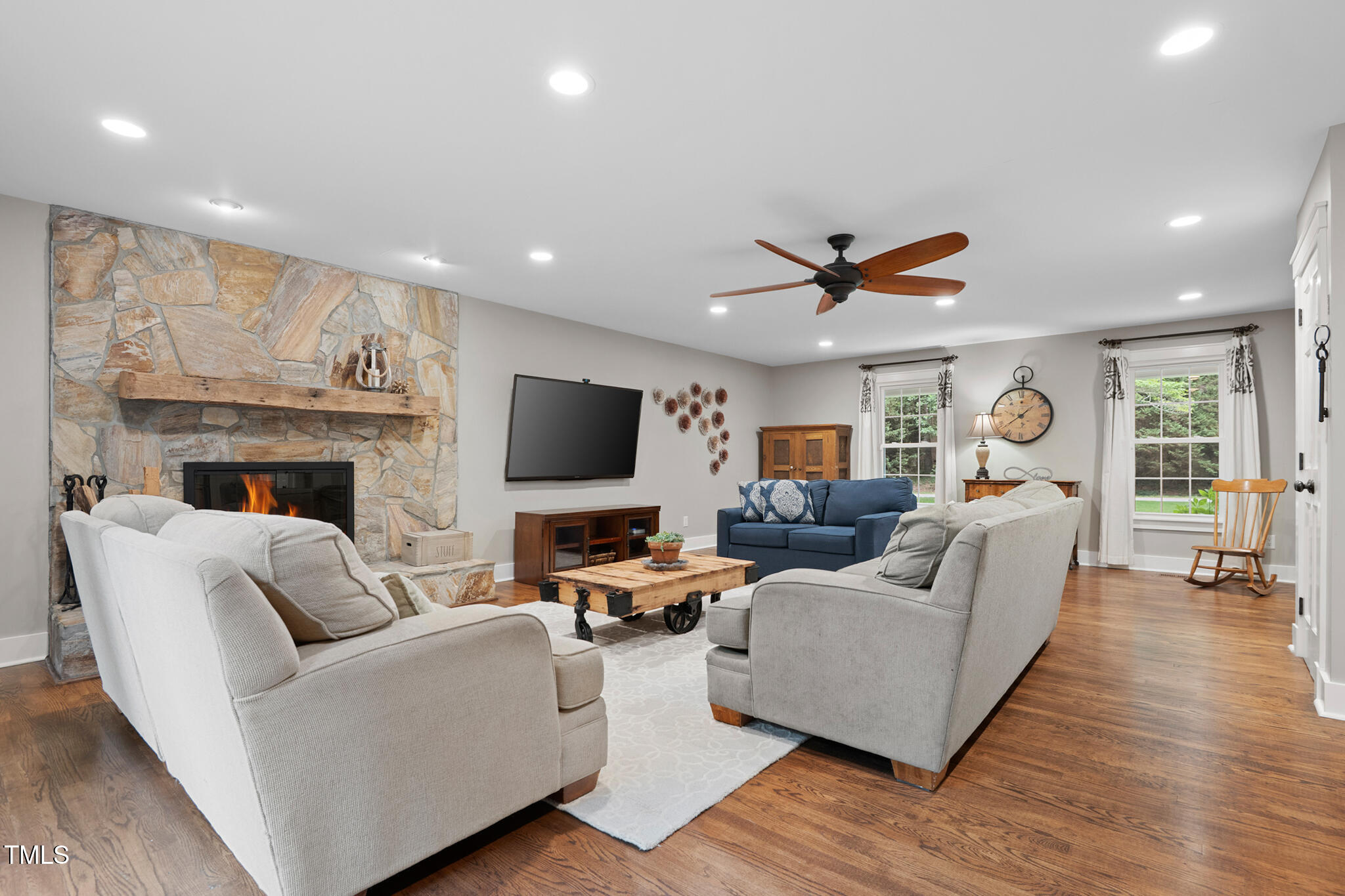 8608 Valley Brook Drive Raleigh, NC 27613 - Photo 13 of 74 a living room with furniture fireplace and a flat screen tv