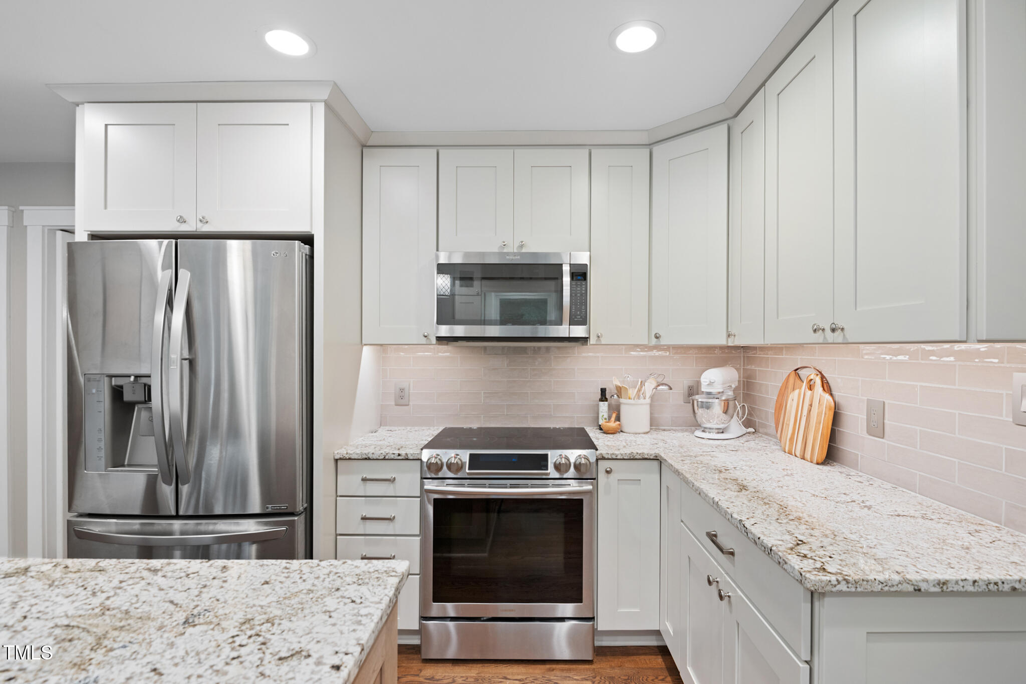 8608 Valley Brook Drive Raleigh, NC 27613 - Photo 17 of 74 a kitchen with stainless steel appliances granite countertop a stove a refrigerator and a sink