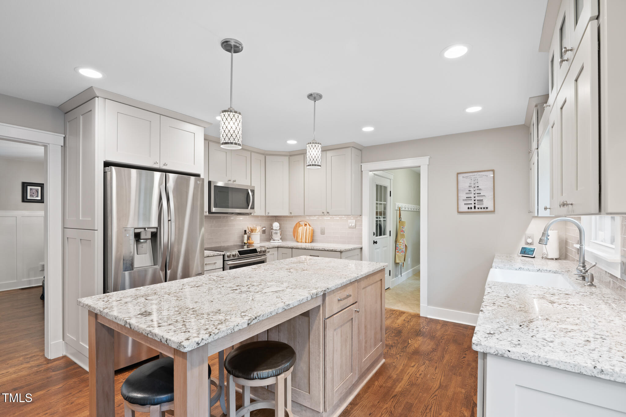 8608 Valley Brook Drive Raleigh, NC 27613 - Photo 19 of 74 a kitchen with stainless steel appliances granite countertop island refrigerator and stove