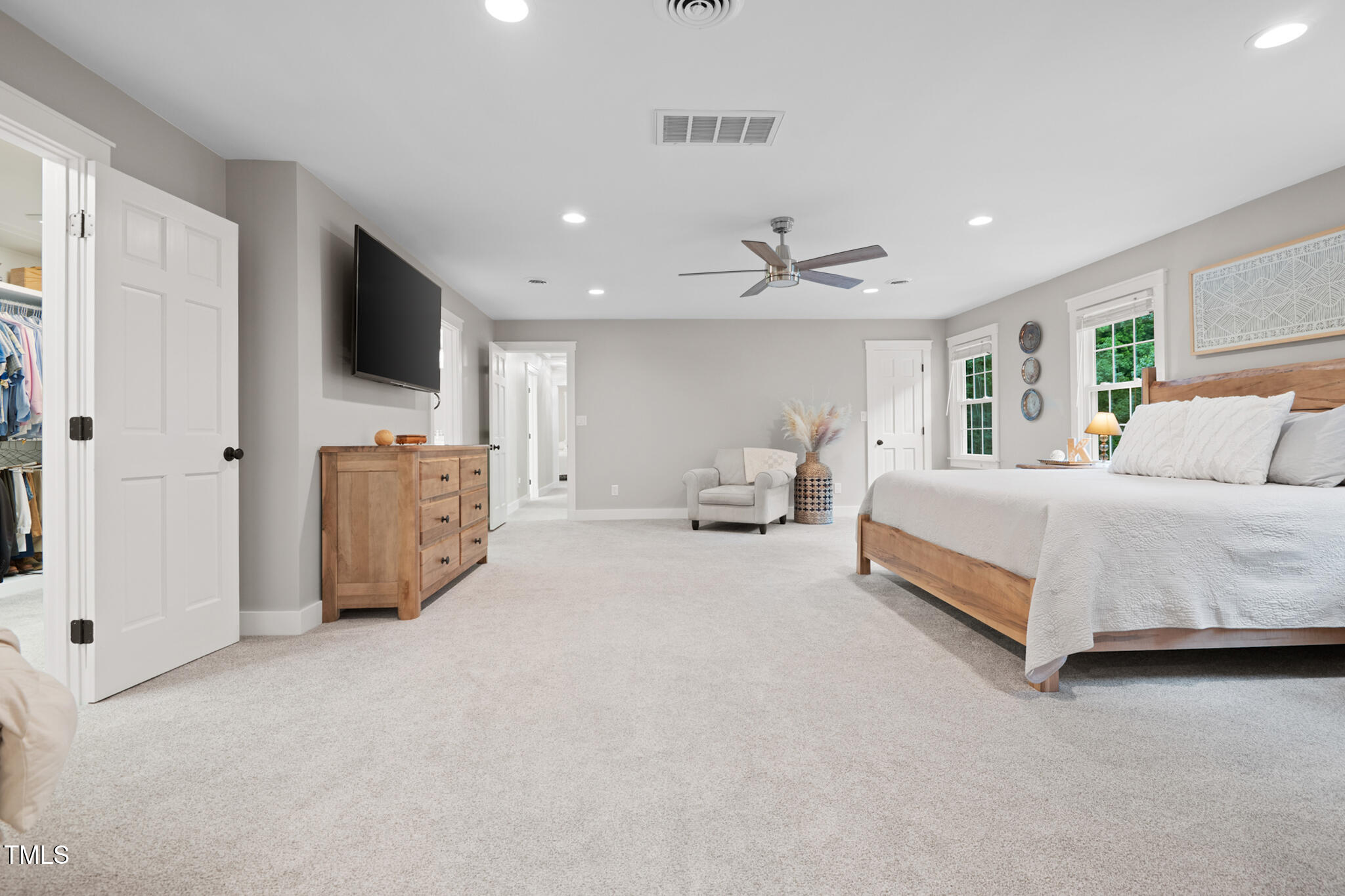 8608 Valley Brook Drive Raleigh, NC 27613 - Photo 27 of 74 a spacious bedroom with a bed a window and a television
