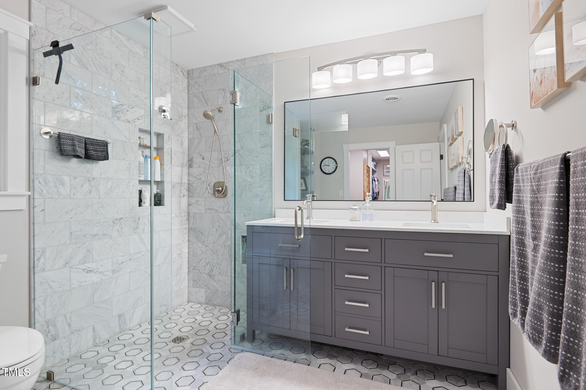 8608 Valley Brook Drive Raleigh, NC 27613 - Photo 31 of 74 a bathroom with a granite countertop sink a toilet a mirror and shower