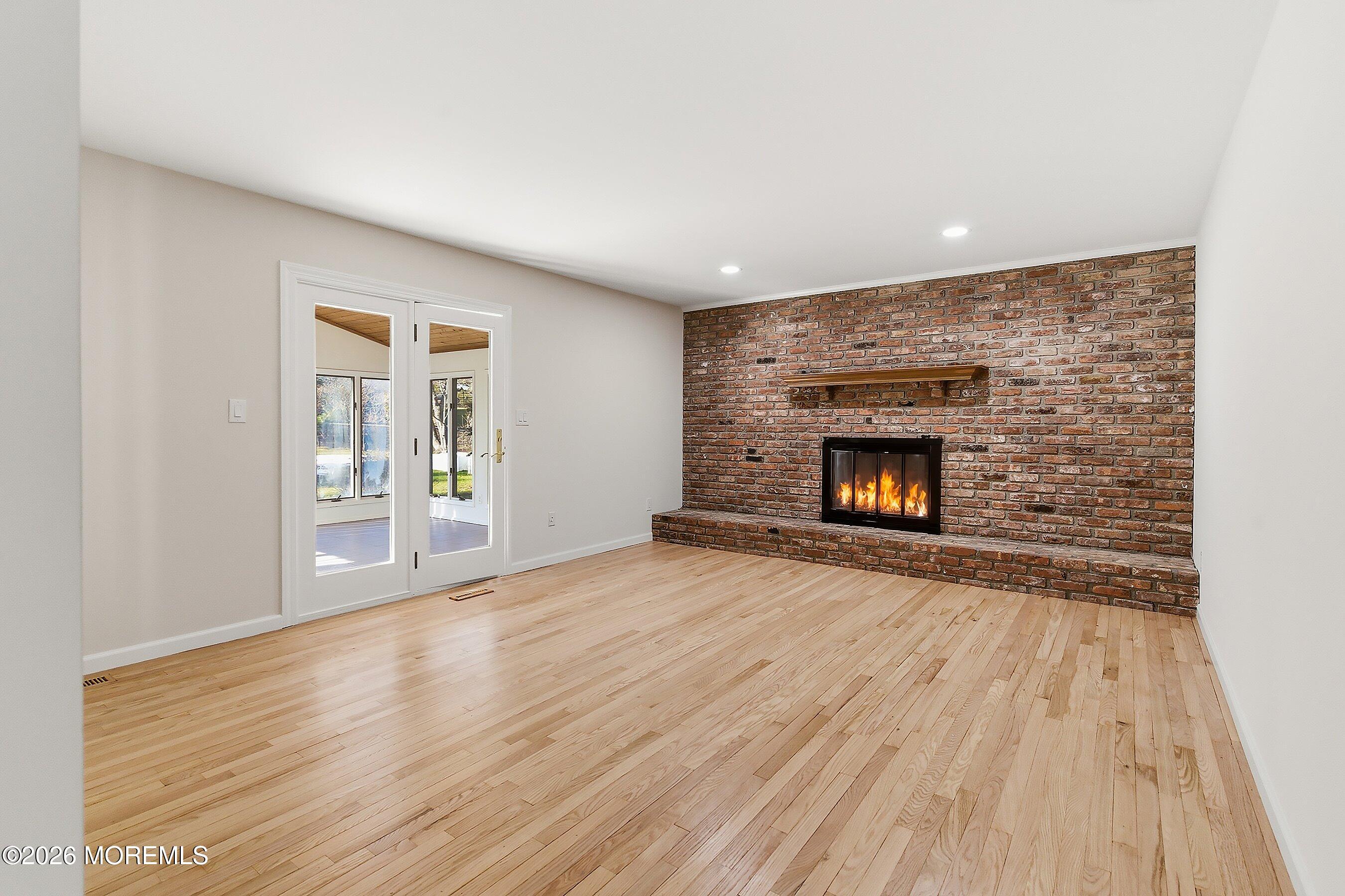 7 Shire Way Middletown, NJ 07748 - Photo 11 of 61 wooden floor fireplace and windows in an empty room