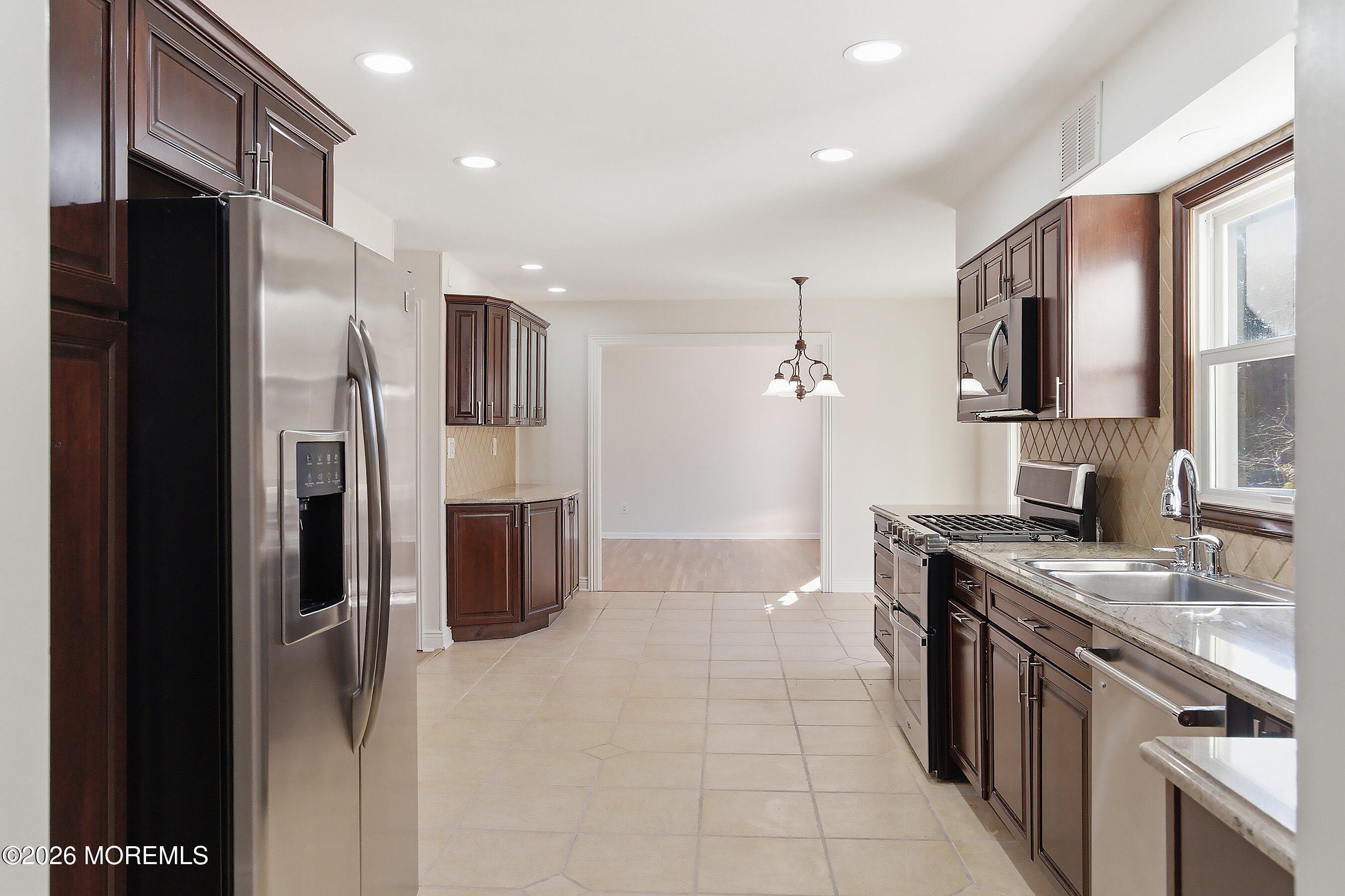 7 Shire Way Middletown, NJ 07748 - Photo 14 of 61 a large kitchen with stainless steel appliances granite countertop a refrigerator and a sink