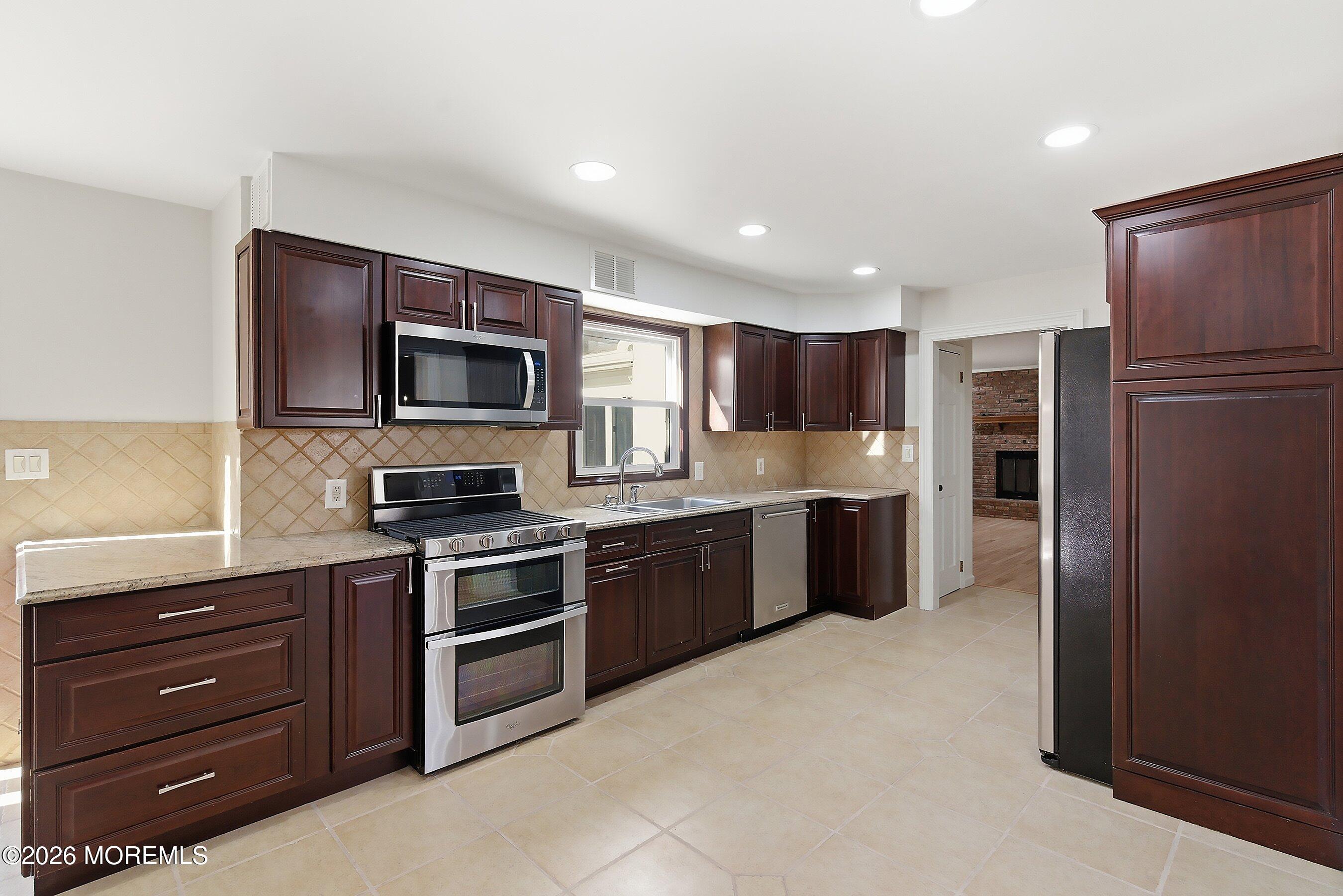 7 Shire Way Middletown, NJ 07748 - Photo 16 of 61 a kitchen with stainless steel appliances granite countertop a refrigerator and a stove top oven