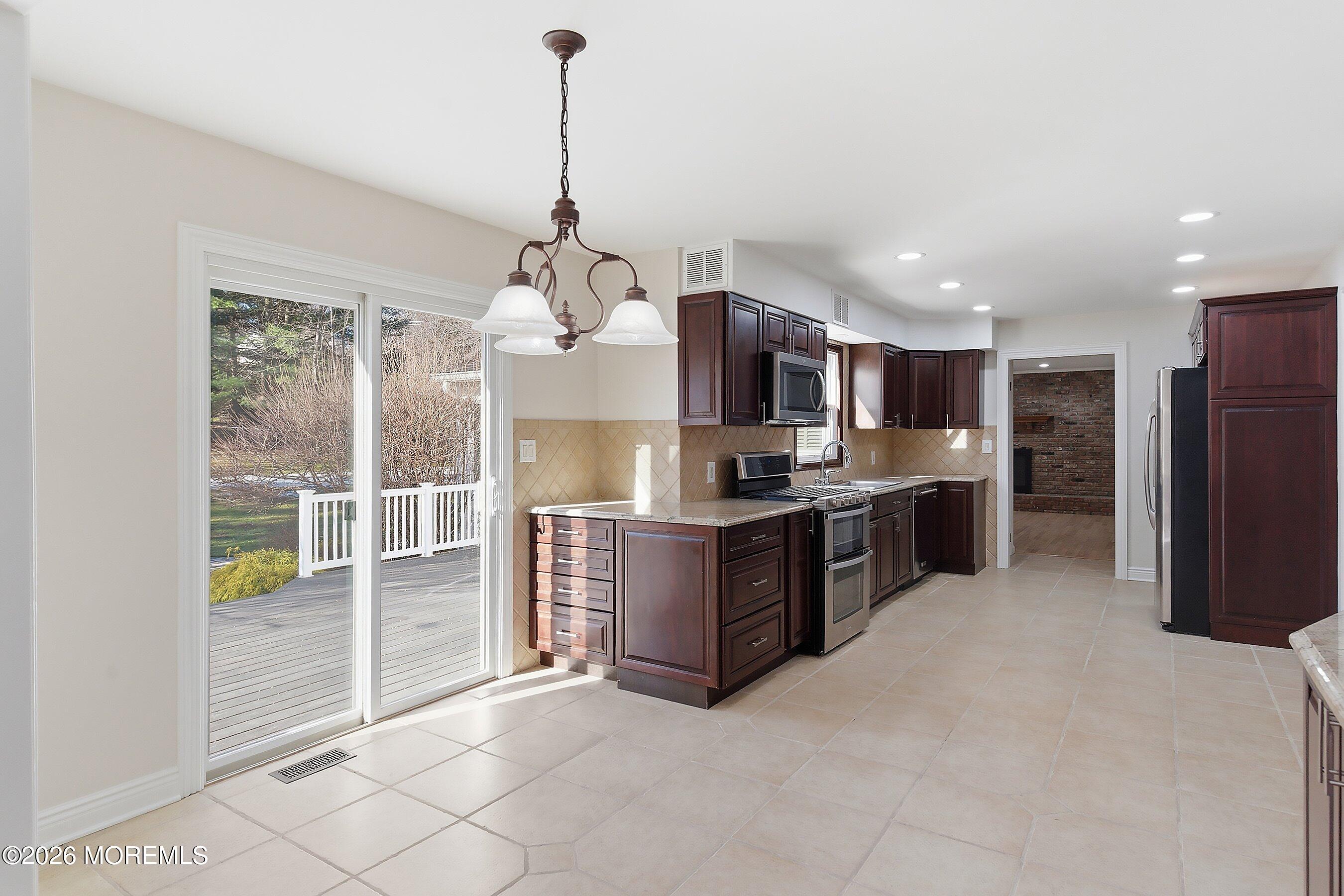 7 Shire Way Middletown, NJ 07748 - Photo 18 of 61 a kitchen with stainless steel appliances granite countertop a refrigerator and a sink
