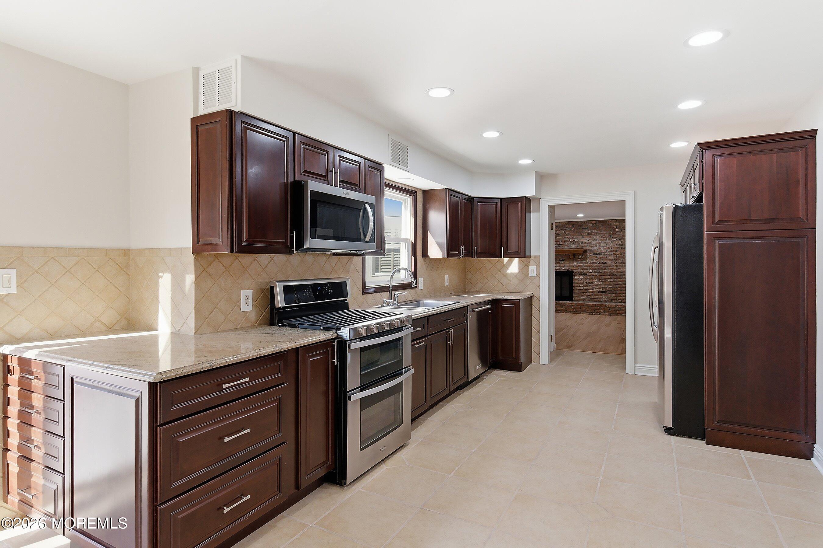 7 Shire Way Middletown, NJ 07748 - Photo 19 of 61 a large kitchen with stainless steel appliances granite countertop a refrigerator and a stove top oven